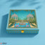 Decorative box with garden design featuring peacocks and a fountain on a blue background
